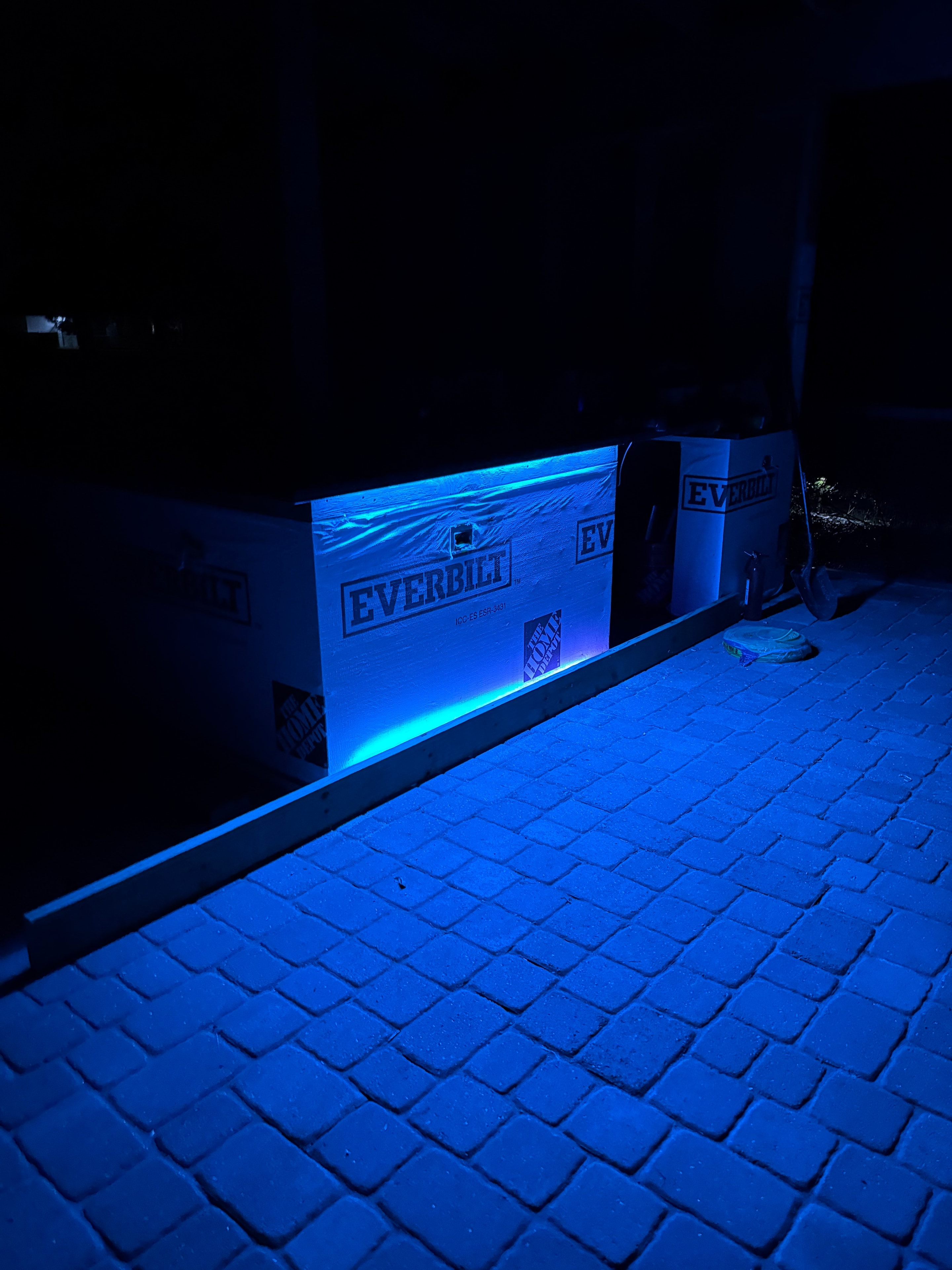 Blue LED strip lighting on outdoor bar — custom lighting design