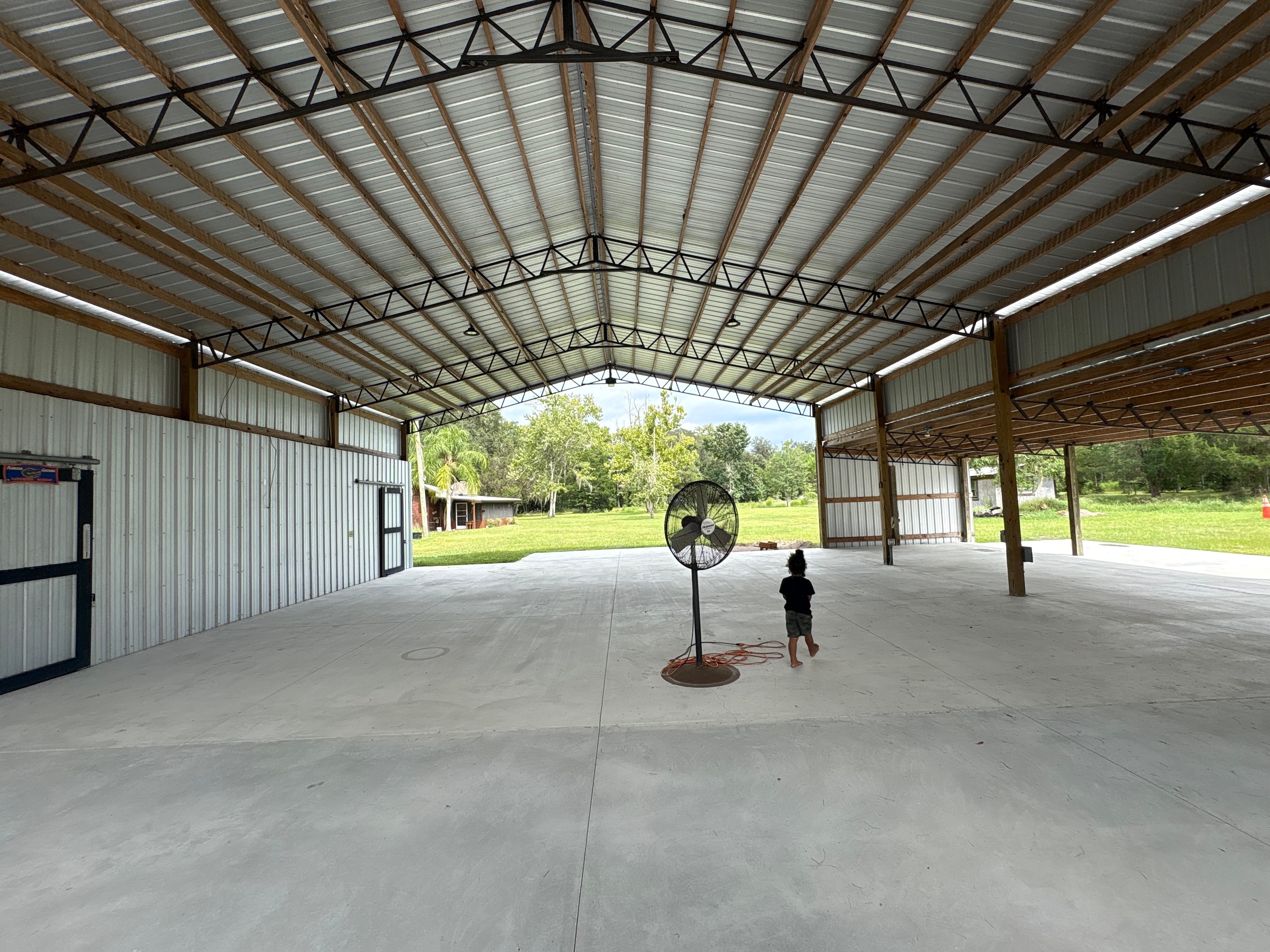 Large metal barn wired with interior lighting — new construction electrical
